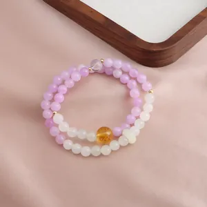 Close-up of double-layer beaded bracelet with purple Kunzite and Citrine crystals.