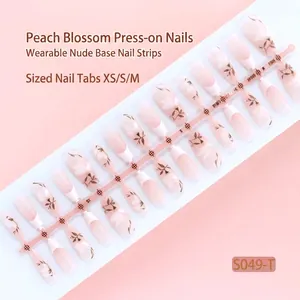 Elegant peach pink floral press-on nails set containing 30 pieces in sizes XS, S, and M