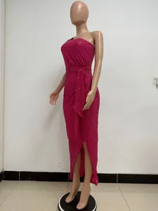 Detailed view of fuchsia sequined one-shoulder maxi dress with waist tie and slit.