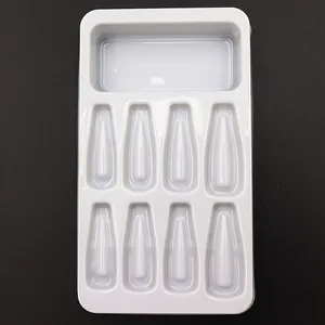 Detailed view of a white plastic blister tray with 8 slots for press-on nails packaging