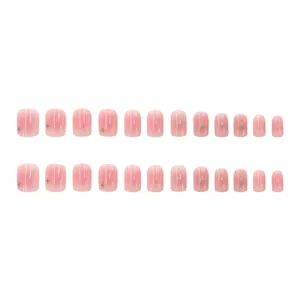 Close-up of nude pink blush press-on nails with delicate silver star patterns