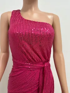 Detail view of fuchsia one-shoulder sequin dress featuring pleated bodice and waist tie design