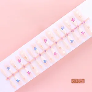 Macro view of sheer pink press-on nails with star patterns on a display strip