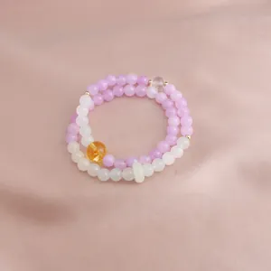 Elegant double-strand beaded bracelet featuring kunzite, citrine and jade stones on satin