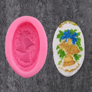 Detailed macro view showing the pink silicone Christmas bell mold alongside its finished decor
