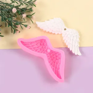 Detail of angel wing silicone mold showing intricate feather textures for fondant.