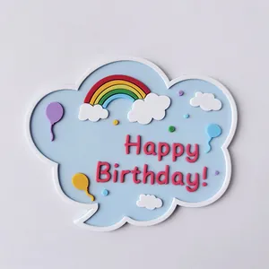 Close-up detail of soft rubber cloud cake topper with rainbow and Happy Birthday text decoration