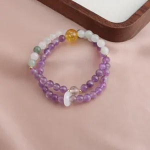 Detailed macro view of purple amethyst and mixed crystal beaded double-strand bracelet
