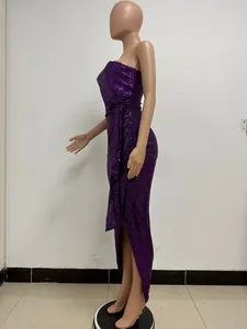 Side view of an elegant purple sequined evening gown featuring waist tie and pleats.