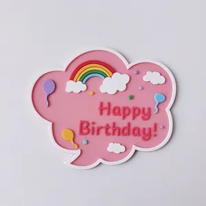 Detailed macro view of pink cloud cake topper with rainbow and Happy Birthday text