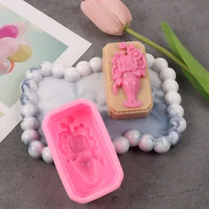 Detail view of a pink silicone flower vase mold with a finished aromatherapy plaster cast.