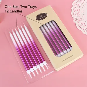 Close-up detail of twelve gradient purple birthday candles in a kraft paper box
