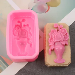 Close-up of pink flower silicone mold and finished floral soap with rose vase design.