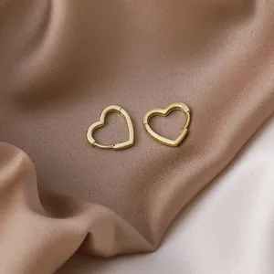 Elegant gold-plated heart-shaped hoop earrings displayed on premium soft silk fabric