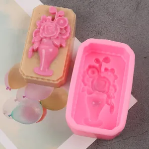 Close-up of pink silicone soap mold with detailed floral bouquet relief design