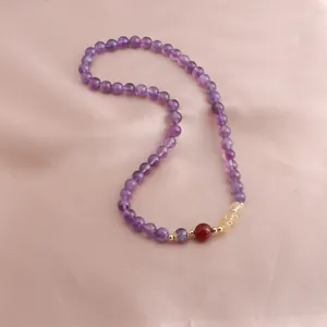 Macro view of a luxury purple amethyst bead bracelet with red and sunstone accents