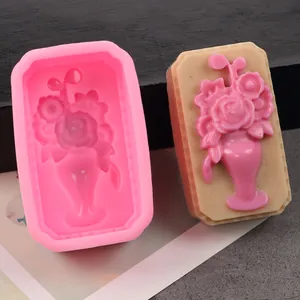Close-up detail of a pink silicone mold and its finished floral soap with vase design