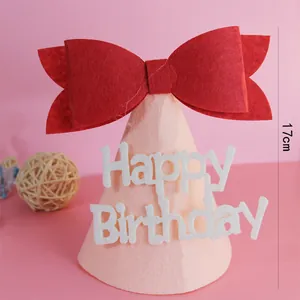 Detalle macro de un gorro de fiesta de fieltro rosa con un lazo rojo grande y medidas