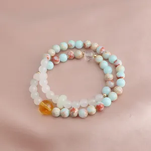 Detailed macro view of a double-layered beaded bracelet featuring citrine and natural stones.
