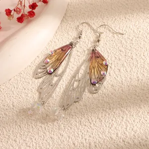 Detailed view of long cicada wing drop earrings with purple gradient and shiny crystals