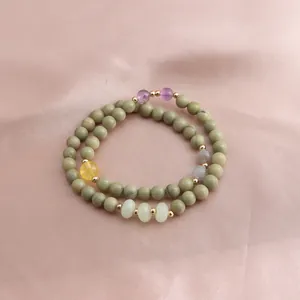Close-up of double-strand Alashan stone bracelet with amethyst and sunstone accents.