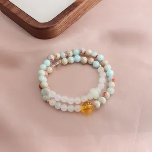 Detail view of a double-layered stone bracelet with colorful jasper and citrine beads