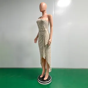 Side detail of elegant champagne sequined one-shoulder dress with waist tie and slit