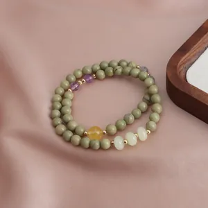 Detail view of New Chinese style double-loop bracelet with green Alashan beads and sunstone