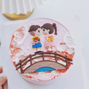 Close-up detail of a romantic cake topper featuring a couple on a bridge for Valentine's Day