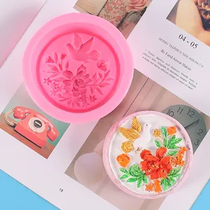 Detail of round silicone mold with dove floral design and a finished painted plaster.