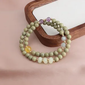 Close-up of a double-strand beaded bracelet with amethyst and sunstone accents.