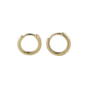 Detailed close-up of polished small gold geometric hoop earrings on a clean white background