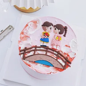 Close-up of romantic couple on a bridge cake topper for Valentine's Day party decor