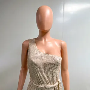 Close-up detail of one-shoulder sequined evening gown featuring a pleated waist