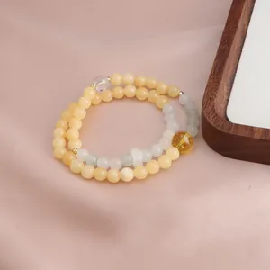 Detailed view of elegant double-strand bracelet with yellow jade and citrine beads