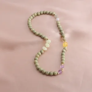 Detail view of Alashan avocado green stone necklace with amethyst and sunstone accents