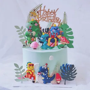 Detailed view of colorful cartoon dinosaur cake toppers on a mint green cake