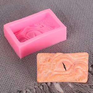Macro detail view of pink silicone mold and a realistic 3D dragon eye soap cast