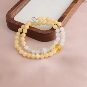 Detailed view of a handmade double-strand golden silk jade and citrine beaded bracelet