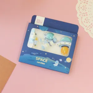 Astronaut and spaceship themed birthday cake candle set in blue retail packaging