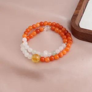 Detailed macro view of a double-strand beaded bracelet featuring orange jade and citrine stones