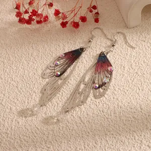Detailed view of long butterfly wing earrings with crystals and gradient colors