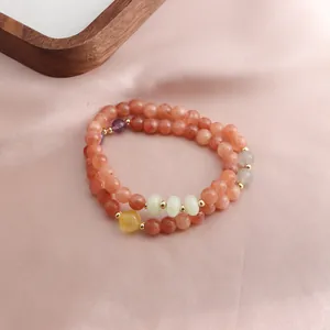 Detailed view of double-wrap bracelet with natural strawberry quartz and amethyst beads