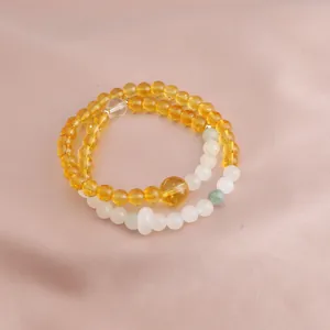Close-up of double-strand bracelet featuring polished yellow citrine and white jade beads