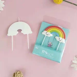 Vibrant colorful rainbow birthday candle with smiley clouds for creative cake decoration