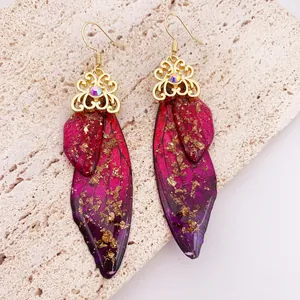 Exquisite detail view of handmade butterfly wing earrings with gold foil and purple gradient