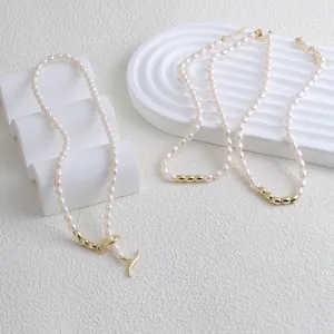 Close-up view of elegant freshwater pearl necklaces with gold bead accents on white displays