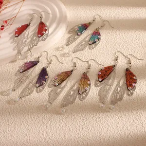 Five pairs of colorful resin butterfly wing drop earrings with rhinestone details.