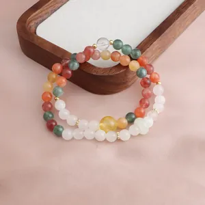 Close-up detail of colorful natural gemstone beads on a New Chinese style double bracelet
