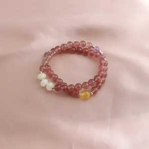 Macro view of a double-strand strawberry quartz bracelet with mixed gemstone accents